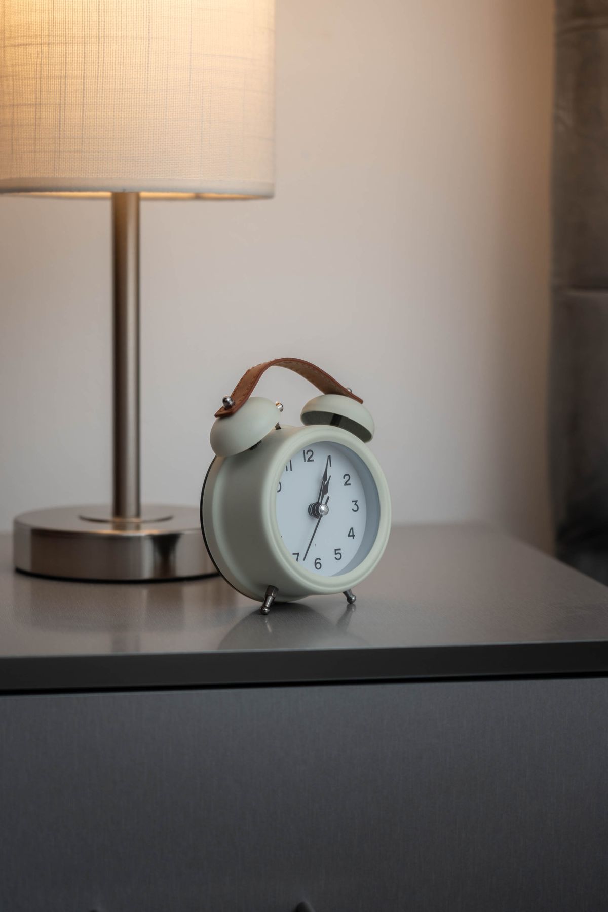 A small alarm clock on a nightstand